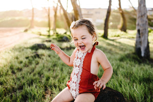 rust boho baby romper with crochet trim on front